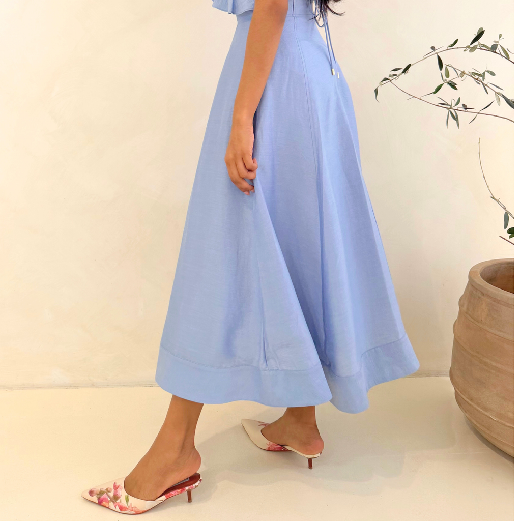 Lady in white getting ready for date night with flora mule kitten heels